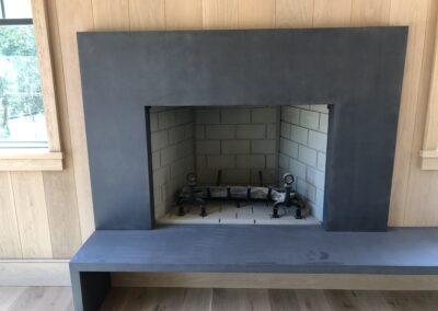 GFRC precast fireplace in wood covered room