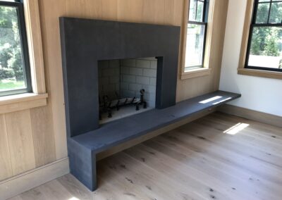 GFRC precast fireplace in wood covered room