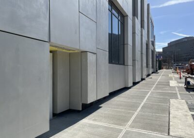 Smooth Glass fiber reinforced concrete paneling shown on the exterior of this community center and garage in queens New York. The facade steps in and out throughout the length.